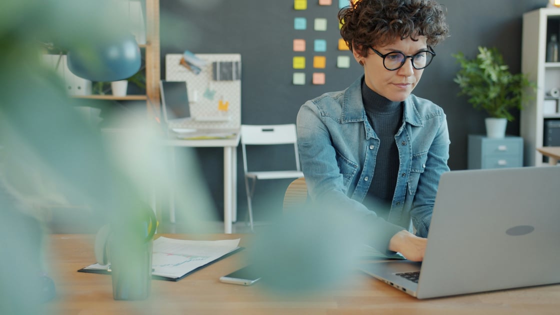 Woman sitting at laptop looking serious